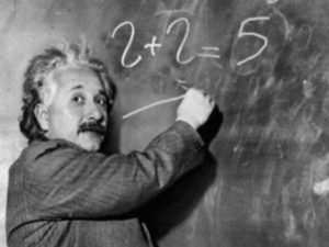 Albert Einstein writes formulas on the blackboard