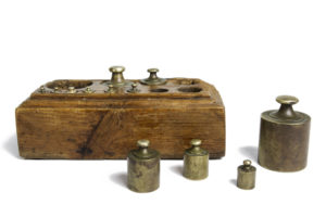 Complete set of antique punched brass weights for scales
